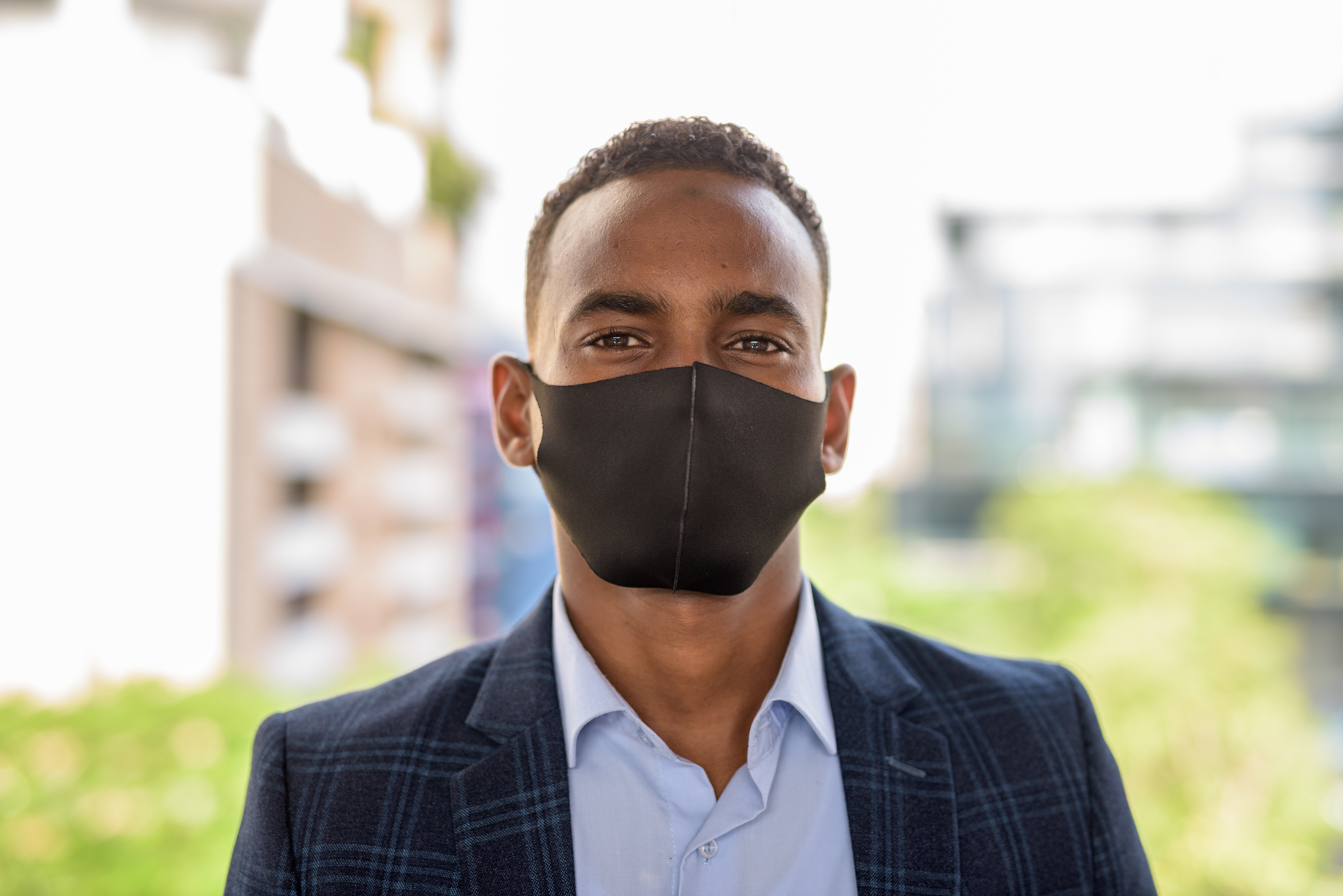 face-of-young-african-businessman-wearing-mask-for-GLA5NSG